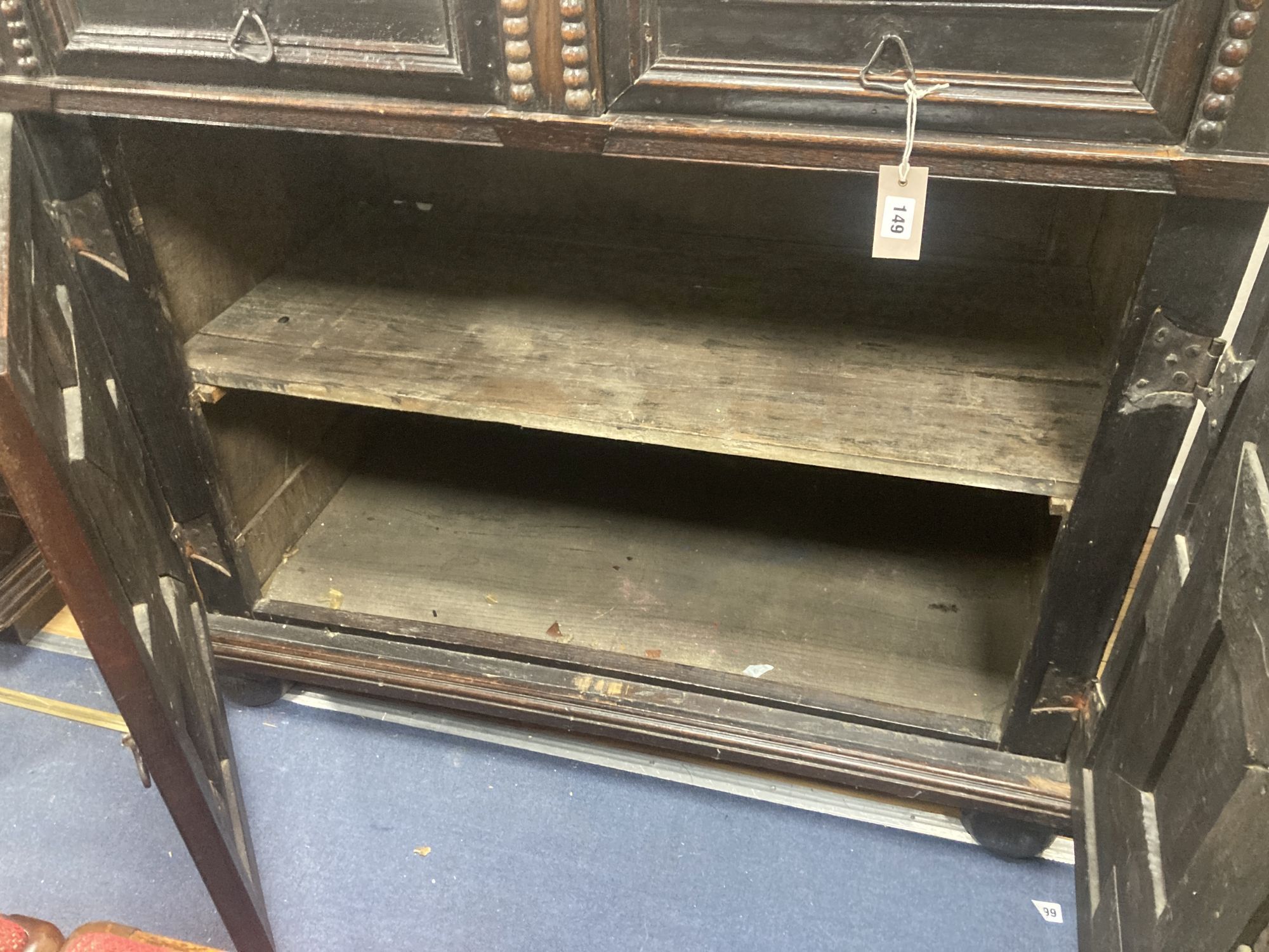 A Jacobean oak cupboard, fitted with a pair of doors, width 111cm, depth 60cm, height 102cm